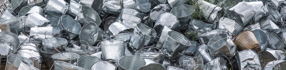 pile of empty metal buckets outdoors