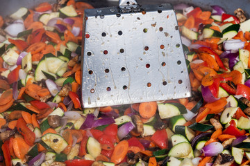 Obraz na płótnie Canvas Cooking of vegetables on big pan outdoors.