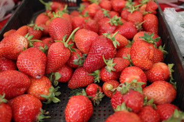 Strawberry. Fresh organic strawberries macro. Fruit background texture. Close up of fresh organic strawberries on a farmer market. 
