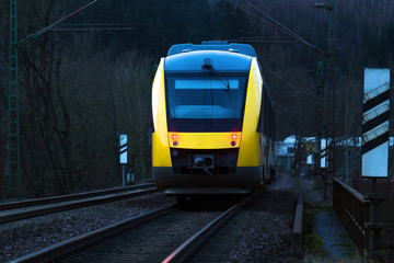 yellow passenger train in the evening