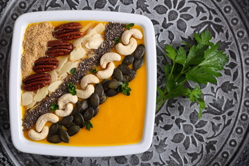 Pumpkin smoothie in a white bowl.