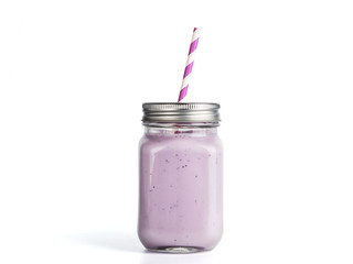 Blueberry smoothie in mason jar glass. Isolated on white with clipping path.