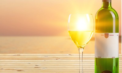 White wine bottle and glass on white background
