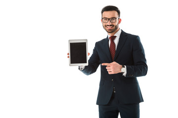 smiling businessman pointing with finger at digital tablet with blank screen isolated on white