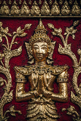 Fototapeta na wymiar Golden Statue on the Doi Suthep Temple Wall in Chiang Mai