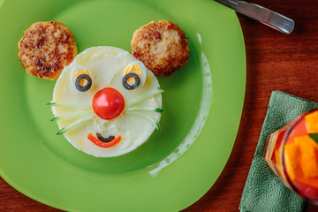 Top view of kid food - funny face made from potato puree and meat.