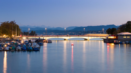 Fototapeta na wymiar Quaibrucke or Quay Bridge across the Limmat river during sunset in Zurich