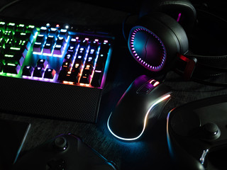 gamer workspace concept, top view a gaming gear, mouse, keyboard with RGB Color, joystick, headset,...
