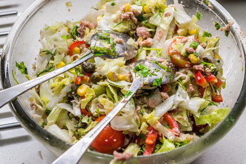 Tuna Fish Salad with Two Spoon Ready to mix in Glass Bowl.