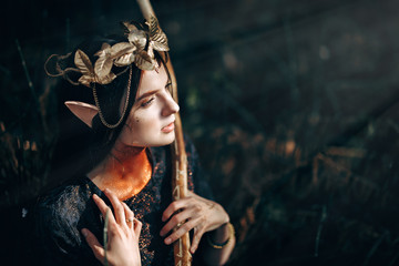 beautiful elf woman fabulous, fairy forest, famtasy young woman with long ears, long dark hair golden wreath crown on head - obrazy, fototapety, plakaty