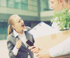 Irate woman is dismissing young manager for violating the job description