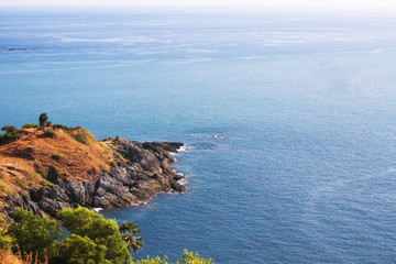 Beautiful seascape with sky twilight of sunset and sea horizon with Calm and blue sky.Dry grass field on mountain of Phrom Thep Cape is famous place in Phuket island, Thailand.
