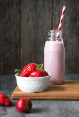 Strawberry smoothie or milkshake on rustic background, healthy food for breakfast and snack