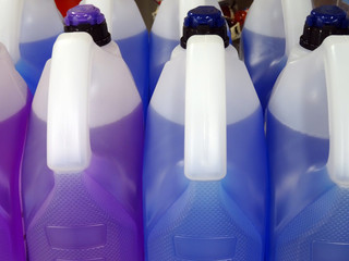 Neutral container of blue and purple cooling liquids -variation Side by side of liquid in arrangement group containers close up of polymers bottle with caps. Beautiful organized for car theme.
