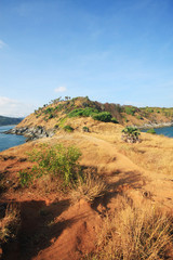 Beautiful seascape with sky twilight of sunset and sea horizon with Calm and blue sky.Dry grass field on mountain of Phrom Thep Cape is famous place in Phuket island, Thailand.