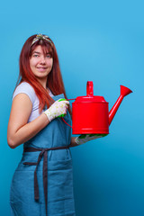 Photo of cheerful florist brunette woman with watering can in hand