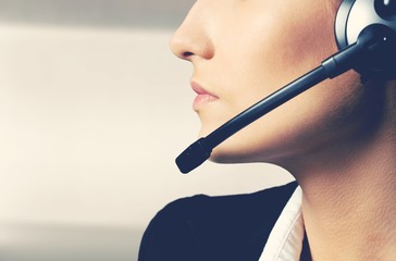 Woman Call Center operator on dark background