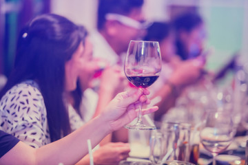 Group of unrecognizable people toasting with wine.