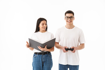 Attractive young couple standing isolated over white