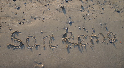inscription sanremo on beach sand