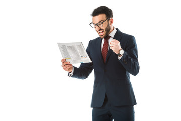 angry businessman reading newspaper and showing fist isolated on white