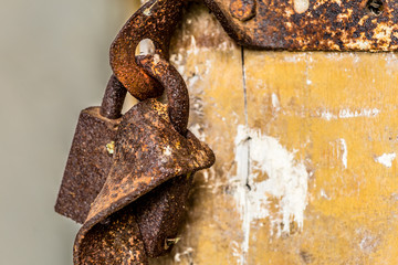 Rusted lock hanging on a door in an abandoned old farm in Belarus, Chernobyl exclusion zone