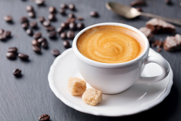 Cup of coffee on black slate background. Close up.