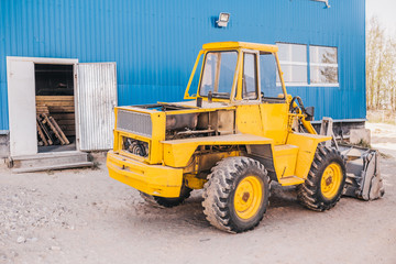 Fototapeta na wymiar Heavy machine with bucket - tractor loader or excavator