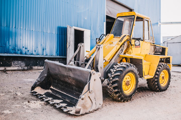 Heavy machine with bucket - tractor loader or excavator