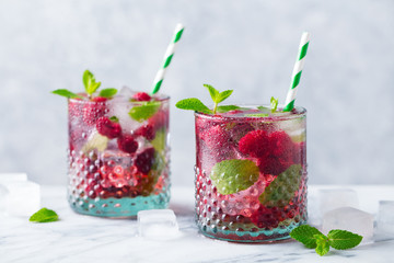 Raspberry cocktail, fizz, lemonade, ice tea with fresh mint on marble background. Close up.