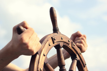 Steering hand wheel ship on sky background - obrazy, fototapety, plakaty