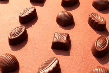 Chocolate candy on brown background. World Chocolate Day.
