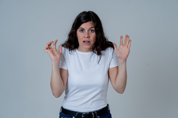 Young attractive scared woman in fear shocked at something scary