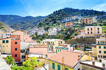 Riomaggiore, Liguria, Italy fisherman village, colorful houses on sunny warm day. Monterosso al Mare, Vernazza, Corniglia, Manarola, and Riomaggiore, Cinque Terre National Park UNESCO World Heritage