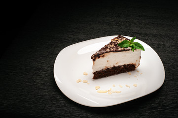 Chocolate dessert bird's milk on a white plate