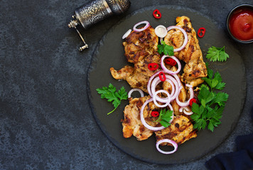 Grilled chicken fillet with tomato sauce and greens.