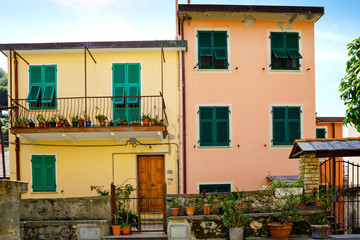 Riomaggiore, Liguria, Italy fisherman village, colorful houses on sunny warm day. Monterosso al Mare, Vernazza, Corniglia, Manarola, and Riomaggiore, Cinque Terre National Park UNESCO World Heritage