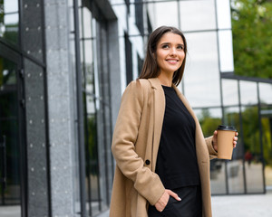Beautiful young businesswoman wearing autumn coat