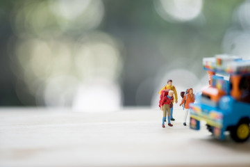 Miniature people : Traveler with backpack hitchhiking Thai farming trucks.