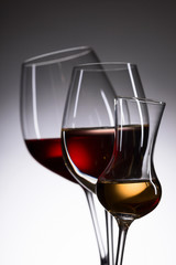 Closeup of glasses with wine and liquor.