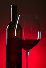 Bottle and glass of red  wine.