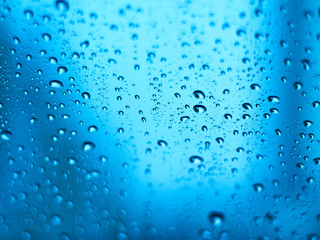 Naklejka na ściany i meble Abstract water droplet on window out of focus