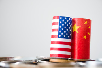 Fototapeta na wymiar USA flag and China flag on coins stacking graph for tariff trade war between United States and China who conflict because of increase tax barrier of import and export product. Government and business.