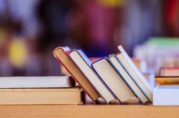 Stack of books at a charity book flea market, text space