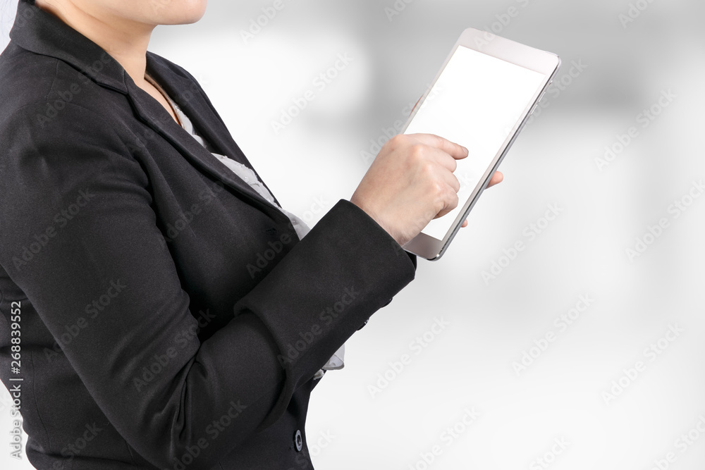 Poster close up of a business woman working on tablet with clipping path on white screen for easy replace you design on tablet screen