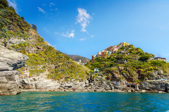 Corniglia, Liguria, Italy fisherman village, colorful houses on sunny warm day. Monterosso al Mare, Vernazza, Corniglia, Manarola and Riomaggiore, Cinque Terre National Park UNESCO World Heritage