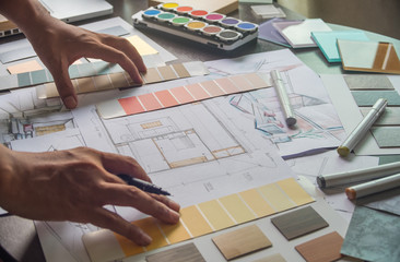 Architect designer Interior creative working hand drawing sketch plan blue print selection material...