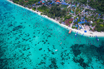 Fototapeta na wymiar Aerial drone view of beautiful tropical Koh Lipe island with crystal clear lagoon sea water during sunny summer day, Thailand