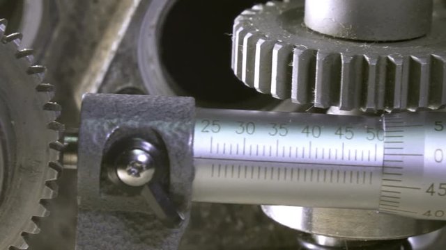 Industrial still life a micrometer against the background of details of cars and mechanisms.Dolly shot