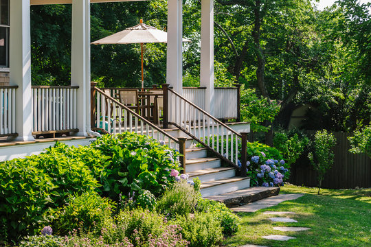 Back Porch of Residence in Summer with Beautiful Garden